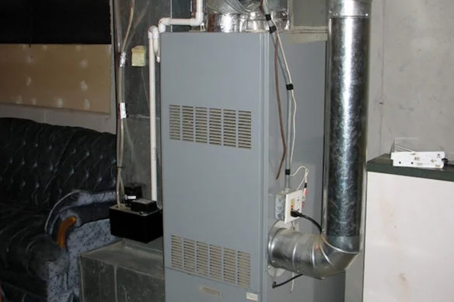 BIM Heating and Cooling technician servicing residential heating system furnace