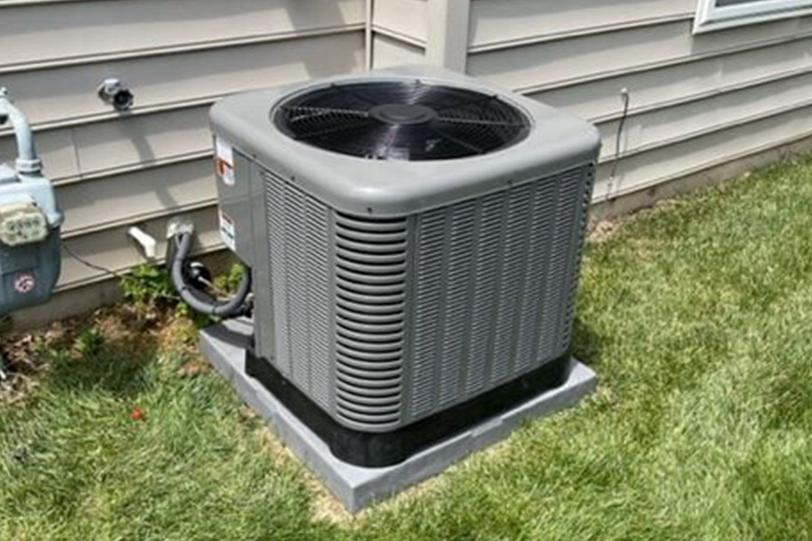 BIM Heating and Cooling installing outdoor AC unit on lawn, helping unlock rebates
